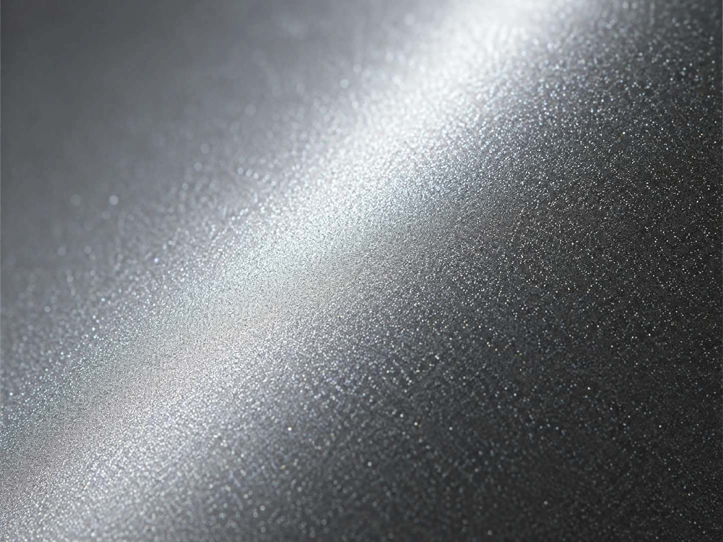 Fine star-like pearlescent particles across a coated aluminium surface
