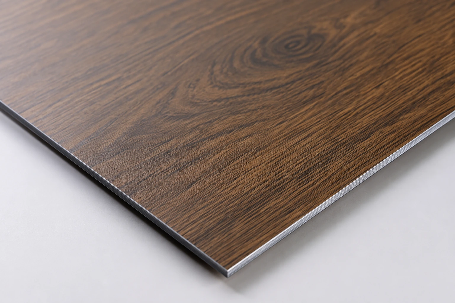 Close view of dark walnut grain on a thin aluminium panel
